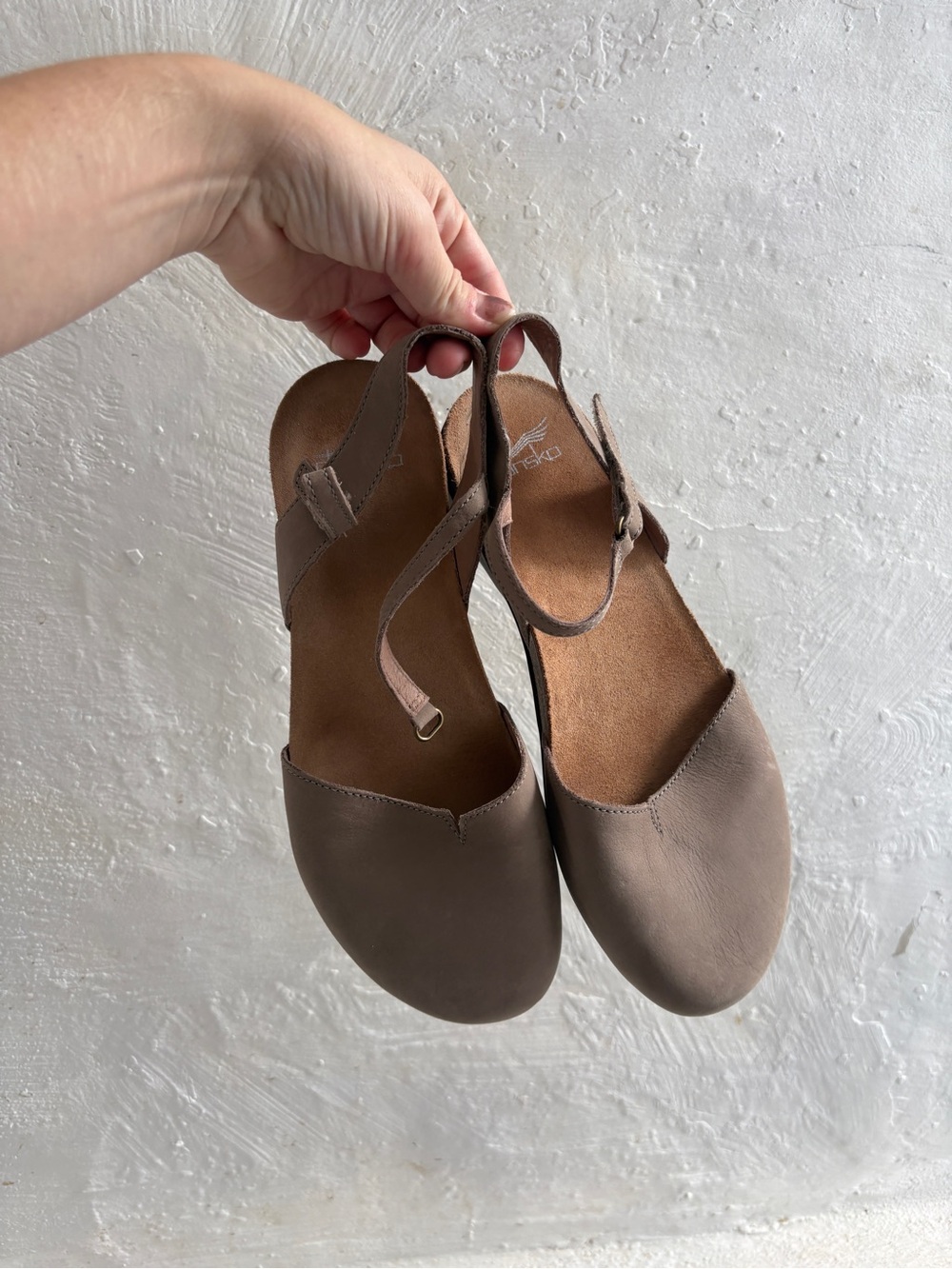 Dansko Women's Rowan closed-toe slingback sandal in a taupe leather finish